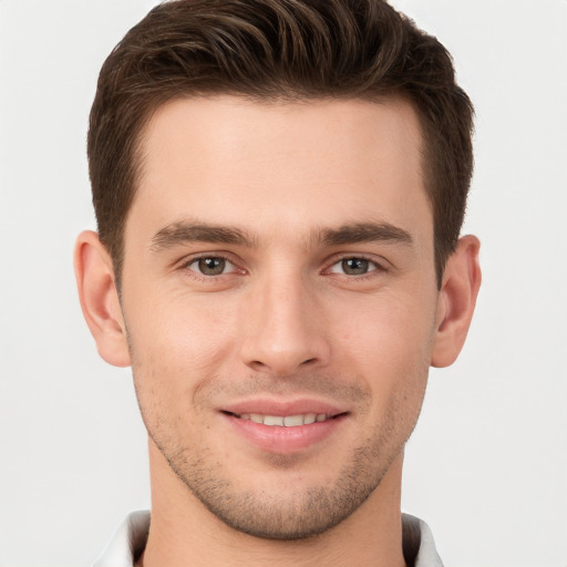 Joyful white young-adult male with short  brown hair and brown eyes