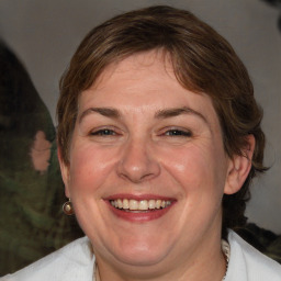 Joyful white adult female with medium  brown hair and blue eyes