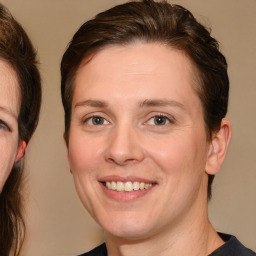 Joyful white adult female with medium  brown hair and brown eyes