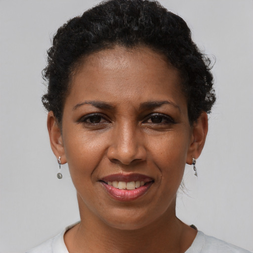 Joyful black adult female with short  brown hair and brown eyes