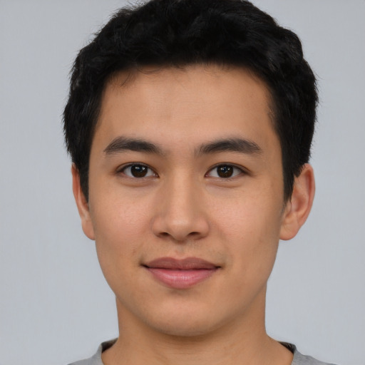 Joyful asian young-adult male with short  black hair and brown eyes