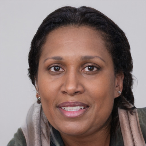 Joyful latino adult female with medium  brown hair and brown eyes