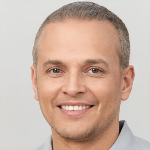 Joyful white adult male with short  brown hair and brown eyes