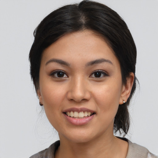 Joyful latino young-adult female with medium  black hair and brown eyes