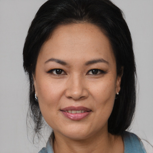 Joyful asian adult female with medium  brown hair and brown eyes