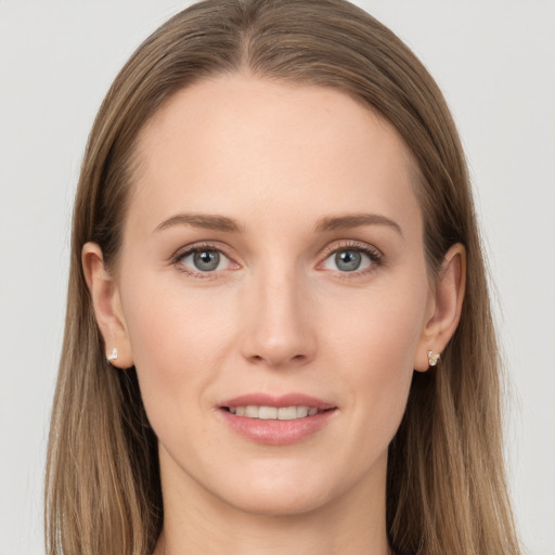 Joyful white young-adult female with long  brown hair and grey eyes