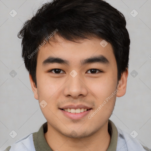 Joyful asian young-adult male with short  black hair and brown eyes