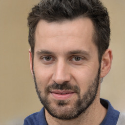 Joyful white young-adult male with short  black hair and brown eyes