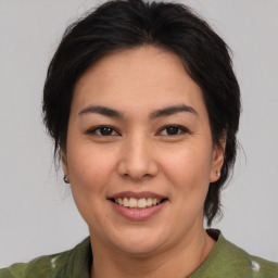 Joyful asian young-adult female with medium  brown hair and brown eyes