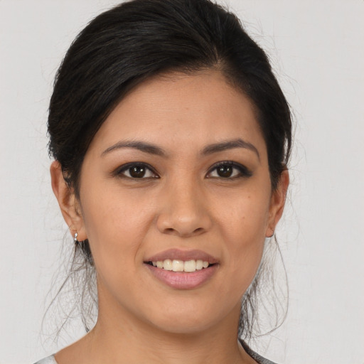 Joyful latino young-adult female with medium  brown hair and brown eyes