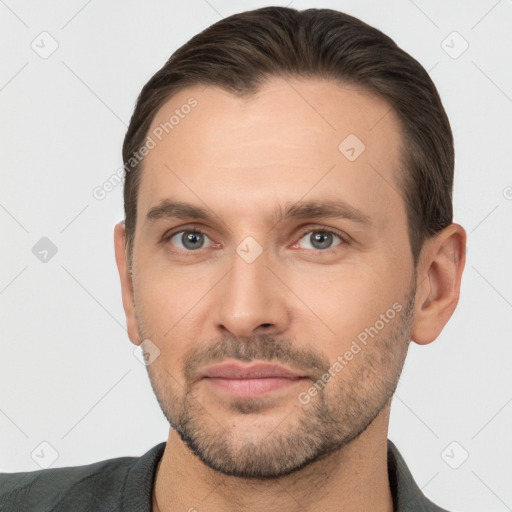 Joyful white adult male with short  brown hair and brown eyes