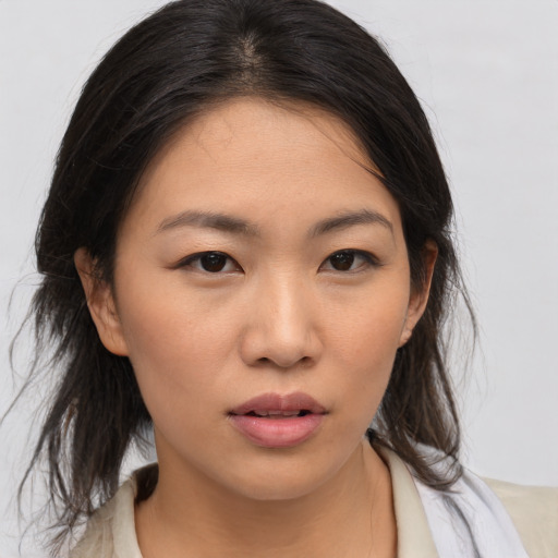 Neutral asian young-adult female with medium  brown hair and brown eyes