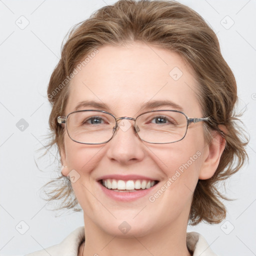 Joyful white adult female with medium  brown hair and blue eyes