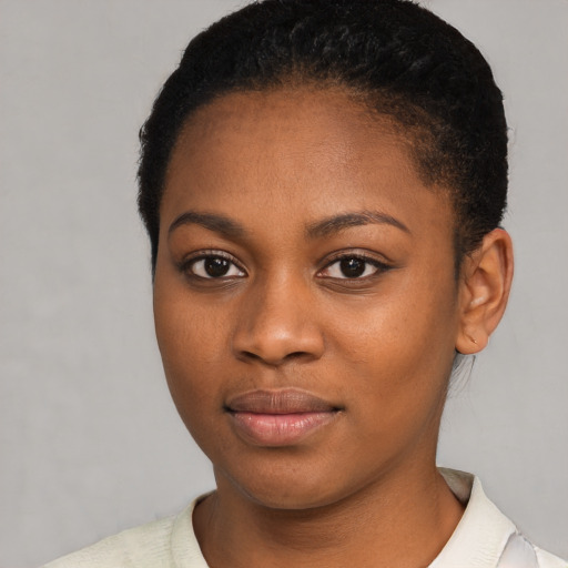 Joyful black young-adult female with short  black hair and brown eyes