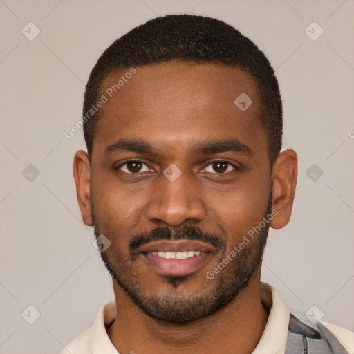 Joyful black young-adult male with short  black hair and brown eyes