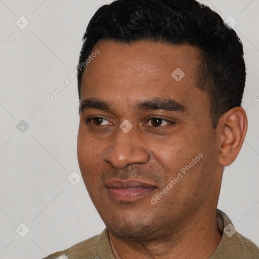 Joyful black young-adult male with short  black hair and brown eyes