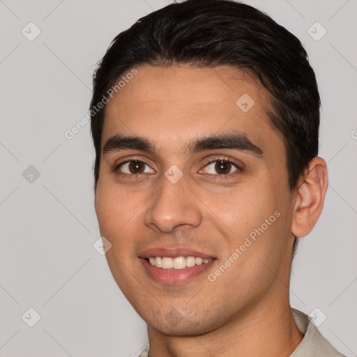 Joyful white young-adult male with short  black hair and brown eyes