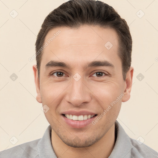 Joyful white young-adult male with short  brown hair and brown eyes