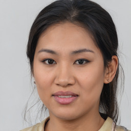 Joyful latino young-adult female with medium  brown hair and brown eyes