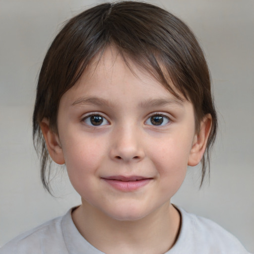 Joyful white child female with medium  brown hair and brown eyes