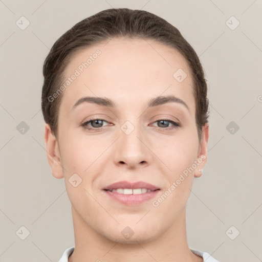 Joyful white young-adult female with short  brown hair and grey eyes