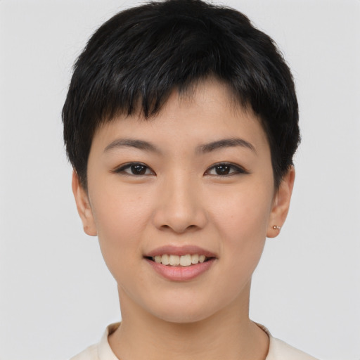 Joyful asian young-adult female with short  black hair and brown eyes