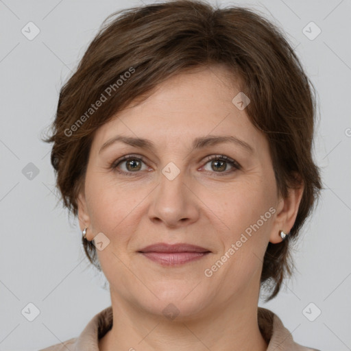 Joyful white adult female with medium  brown hair and grey eyes