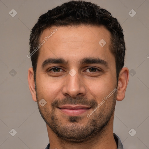 Joyful white young-adult male with short  black hair and brown eyes