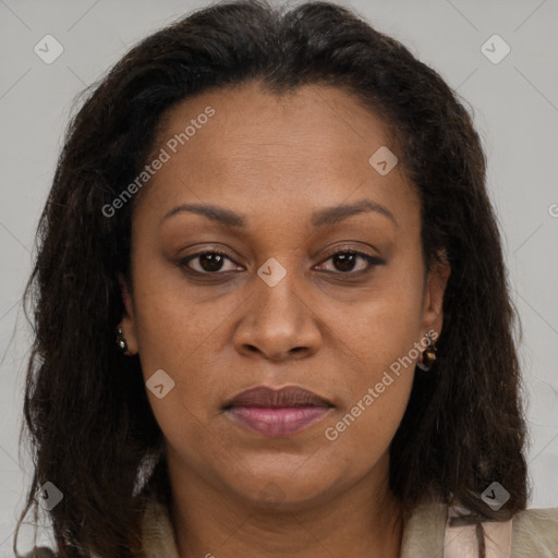 Joyful black adult female with long  brown hair and brown eyes