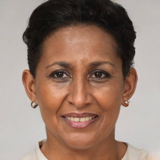 Joyful black adult female with short  brown hair and brown eyes