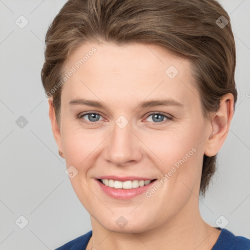 Joyful white young-adult female with short  brown hair and grey eyes