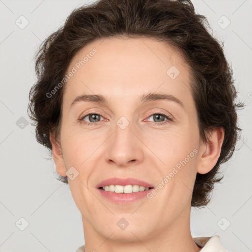 Joyful white adult female with medium  brown hair and green eyes