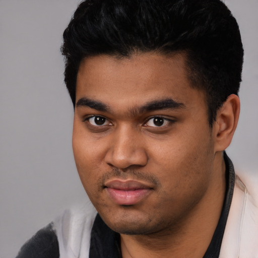Joyful latino young-adult male with short  black hair and brown eyes