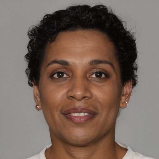 Joyful black adult female with short  brown hair and brown eyes