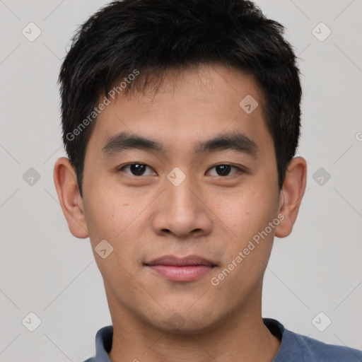 Joyful asian young-adult male with short  black hair and brown eyes