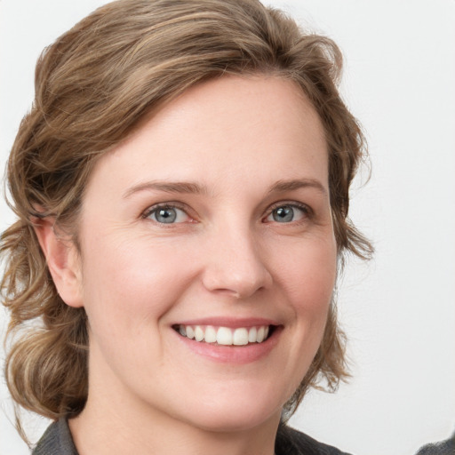 Joyful white young-adult female with medium  brown hair and blue eyes