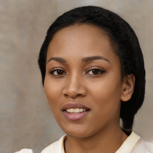 Joyful black young-adult female with medium  black hair and brown eyes