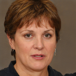 Joyful white adult female with medium  brown hair and grey eyes