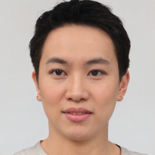 Joyful asian young-adult male with short  brown hair and brown eyes