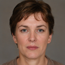 Joyful white adult female with short  brown hair and brown eyes