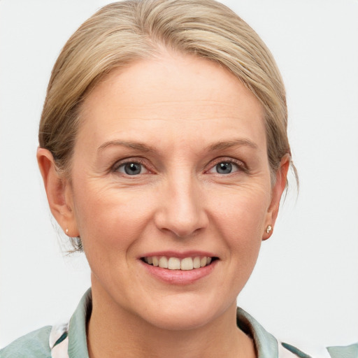 Joyful white adult female with short  brown hair and blue eyes