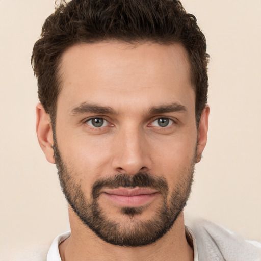 Joyful white young-adult male with short  brown hair and brown eyes