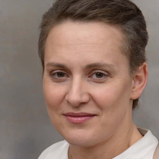 Joyful white adult female with short  brown hair and brown eyes