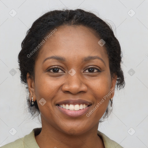 Joyful black adult female with long  brown hair and brown eyes