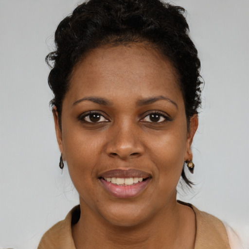 Joyful black young-adult female with short  brown hair and brown eyes