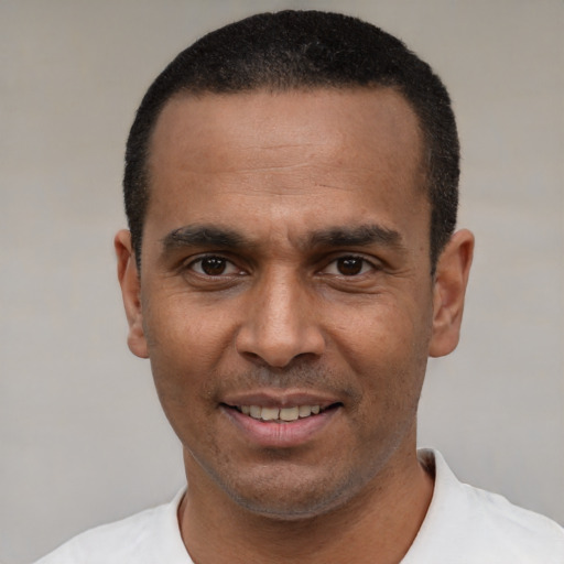 Joyful latino adult male with short  black hair and brown eyes