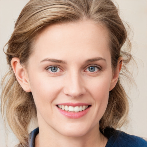 Joyful white young-adult female with medium  brown hair and blue eyes