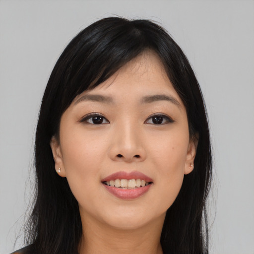 Joyful asian young-adult female with long  black hair and brown eyes