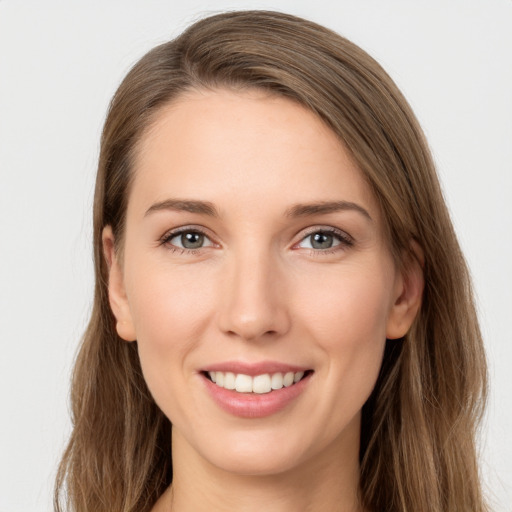 Joyful white young-adult female with long  brown hair and grey eyes