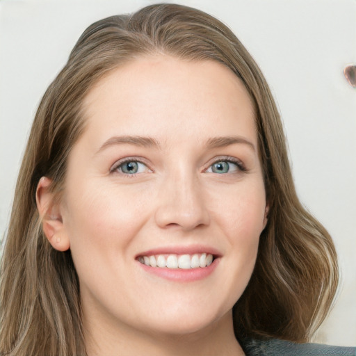 Joyful white young-adult female with long  brown hair and grey eyes